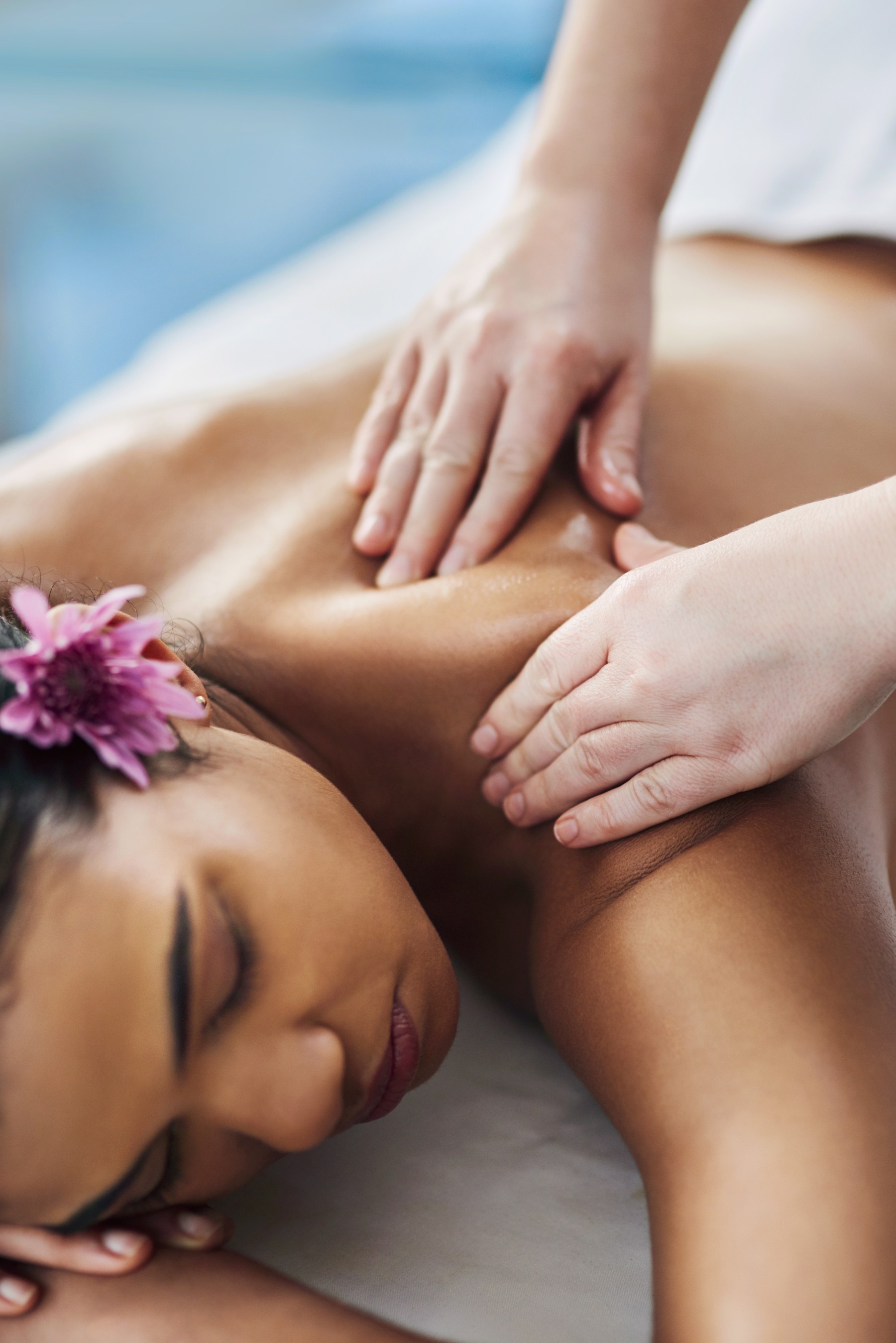 Lady laying on massage bed getting hot stone massage