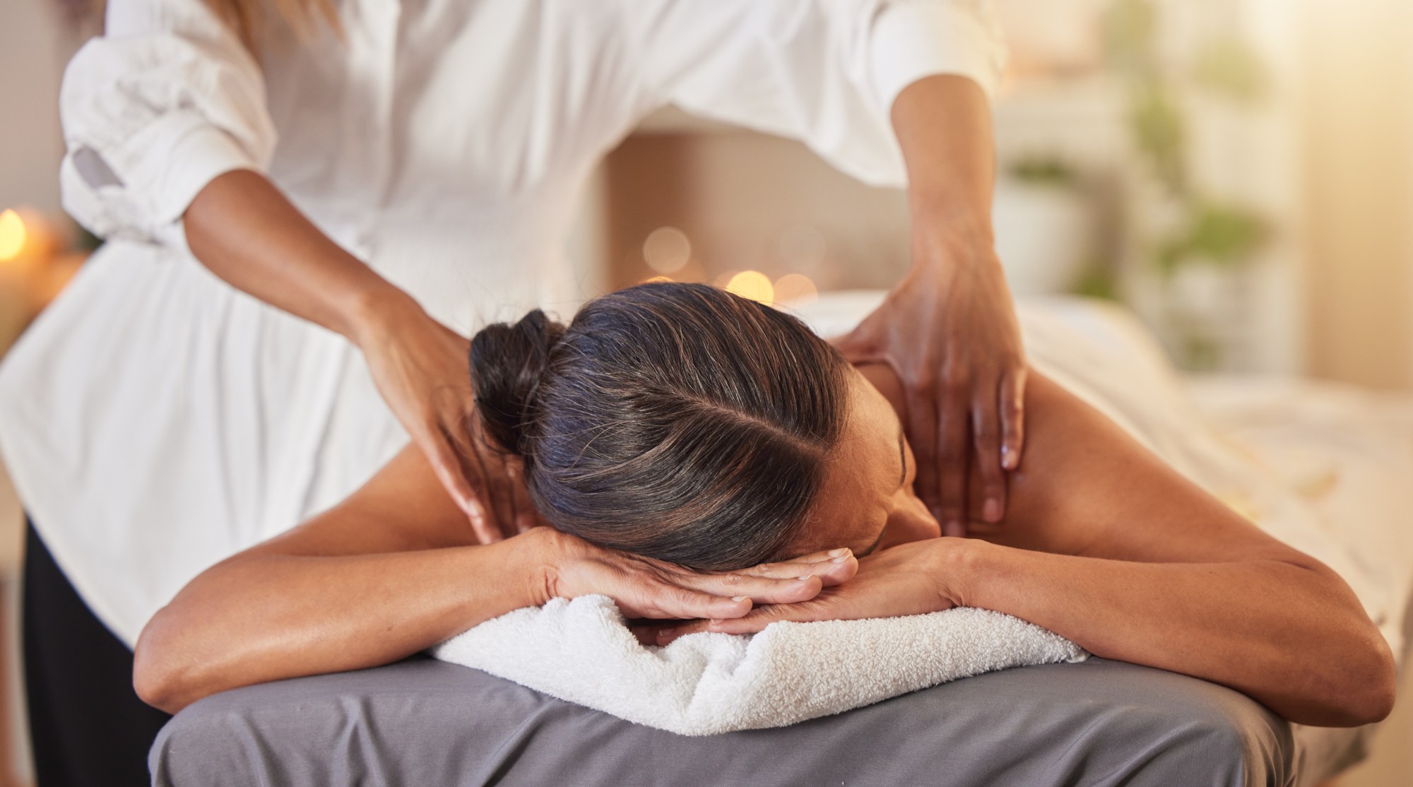 Woman laying faced down getting back massage